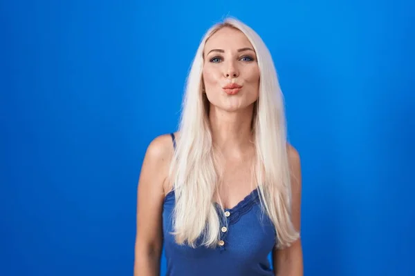 Caucasian Woman Standing Blue Background Looking Camera Blowing Kiss Air — Zdjęcie stockowe