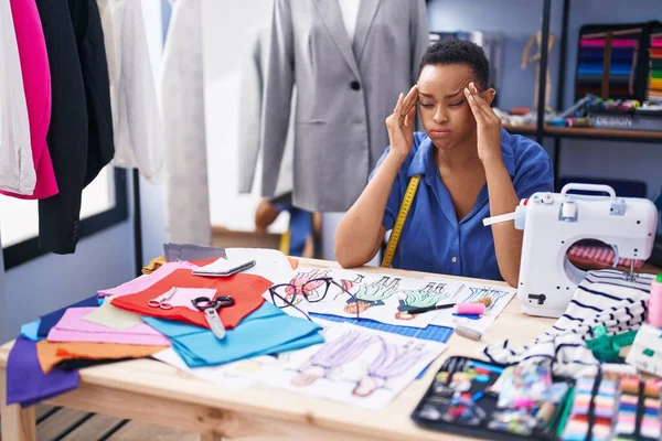 African american woman tailor stressed working at tailor shop