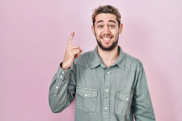 Hispanic Man Beard Standing Pink Background Pointing Finger Successful Idea — Stockfoto
