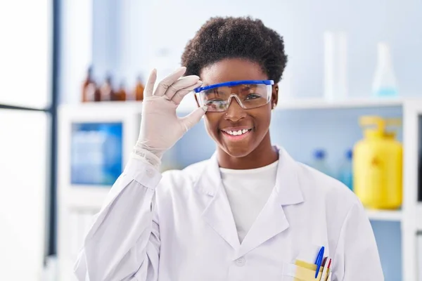 身穿科学家制服站在实验室的非裔美国妇女 — 图库照片