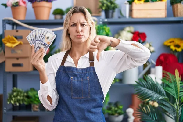 Young Blonde Woman Working Florist Shop Holding Dollars Angry Face — Stockfoto