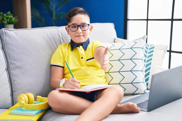 Young Hispanic Kid Doing Homework Sitting Sofa Smiling Friendly Offering — Stok fotoğraf