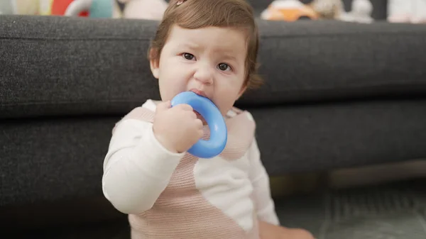 Adorable Toddler Bitting Plastic Hoop Sitting Floor Home — Zdjęcie stockowe