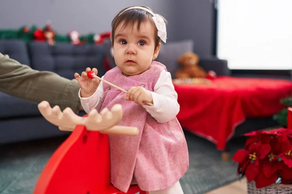 Adorable Hispanic Baby Playing Reindeer Rocking Christmas Decoration Home — Stock Photo, Image