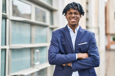 African american man executive smiling confident standing with arms crossed gesture at street