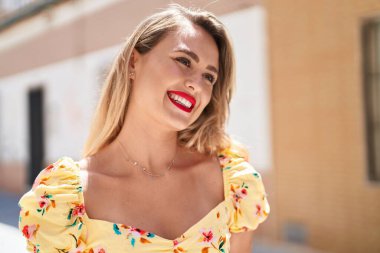 Young beautiful hispanic woman smiling confident looking to the side at street