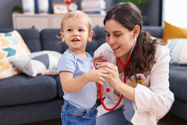 stock image Mother and son doctor examining child at home