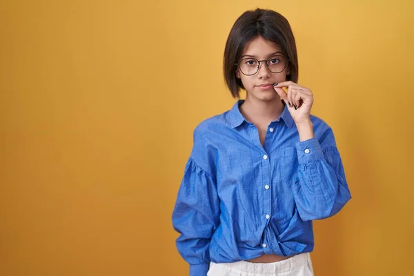 Young Girl Standing Yellow Background Mouth Lips Shut Zip Fingers — 图库照片