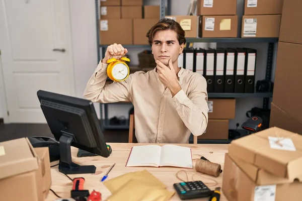Young Man Working Small Business Ecommerce Holding Alarm Clock Serious — Stock fotografie