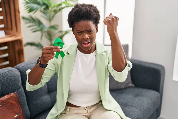 African American Woman Holding Support Green Ribbon Annoyed Frustrated Shouting — Stockfoto