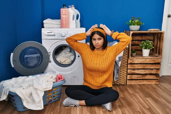 Young Hispanic Woman Doing Laundry Doing Bunny Ears Gesture Hands —  Fotos de Stock