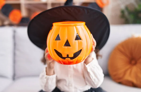 Adorable Hispanic Girl Wearing Halloween Costume Holding Pumpkin Basket Face — Stok fotoğraf
