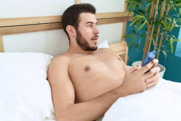 Fiatal Spanyol Férfi Használ Okostelefon Feküdt Ágyban Hálószobában — Stock Fotó