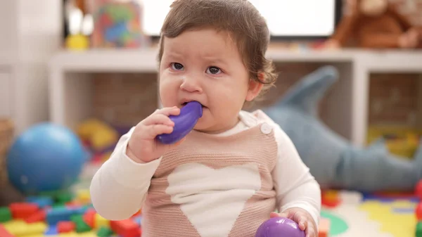 Adorable Toddler Bitting Plastic Food Toy Sitting Floor Kindergarten — Stok fotoğraf