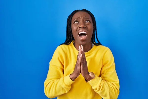 Beautiful Black Woman Standing Blue Background Begging Praying Hands Together — Foto Stock