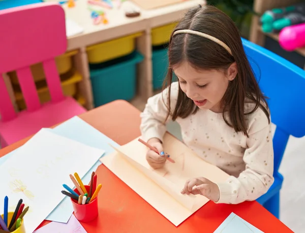 Adorable Hispanic Girl Preschool Student Sitting Table Drawing Paper Kindergarten — 스톡 사진