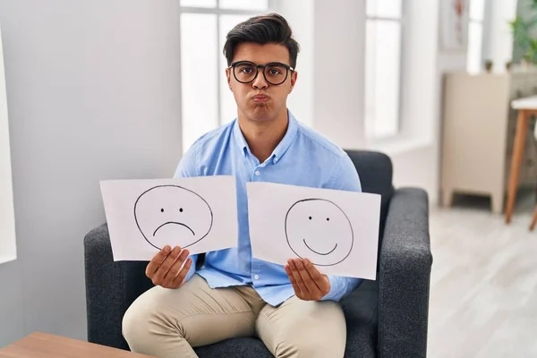 Hispanic Man Working Depression Holding Sad Happy Emotion Paper Puffing — Zdjęcie stockowe