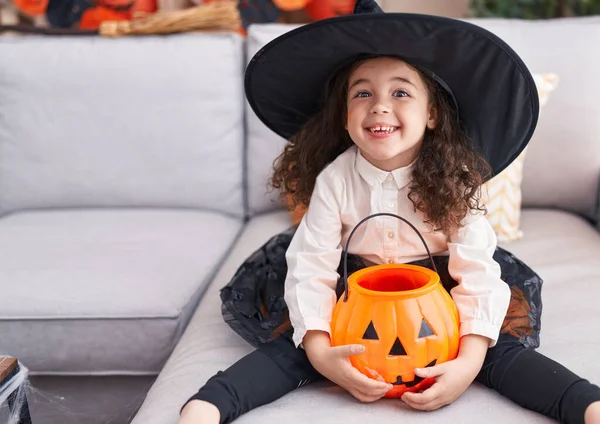 Adorable Hispanic Girl Wearing Halloween Costume Holding Pumpkin Basket Home — Stok fotoğraf