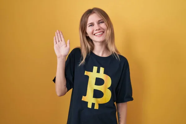 Blonde Caucasian Woman Wearing Bitcoin Shirt Waiving Saying Hello Happy — Stockfoto