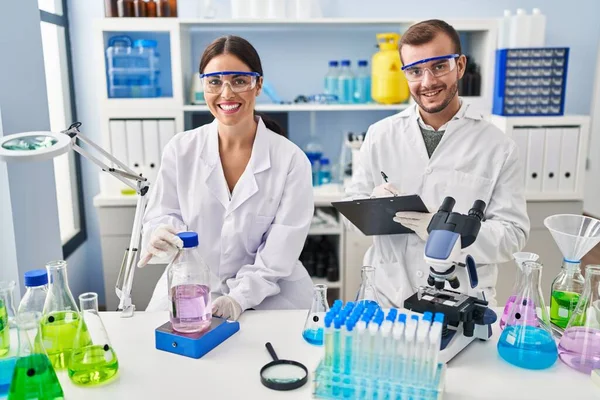 Man Woman Scientist Partners Write Clipboard Measuring Liquid Working Laboratory — Stock Photo, Image