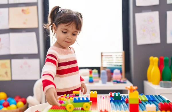 Adorable Hispanic Girl Playing Construction Blocks Standing Kindergarten — Fotografia de Stock