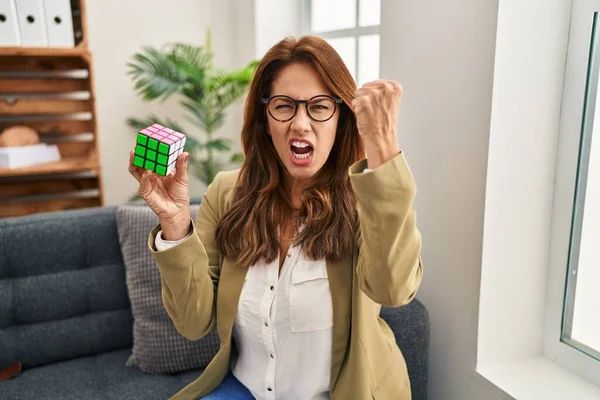 Hispanic Woman Playing Colorful Puzzle Cube Intelligence Game Annoyed Frustrated — Stockfoto