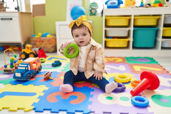Anaokulundaki Sevimli Sarışın Çocuk Elinde Çember Oyuncağıyla Yerde Oturuyor — Stok fotoğraf