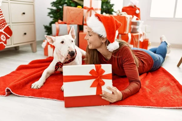 Young Caucasian Woman Unboxing Gift Lying Dog Christmas Tree Home — ストック写真