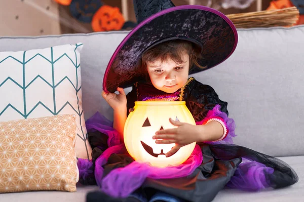 Adorable Hispanic Girl Wearing Halloween Costume Holding Pumpkin Basket Lamp — Stok fotoğraf