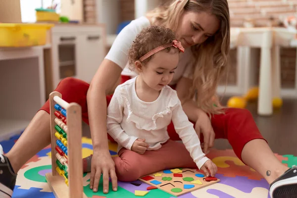 Teacher Toddler Playing Maths Puzzle Game Sitting Floor Kindergarten — Foto Stock