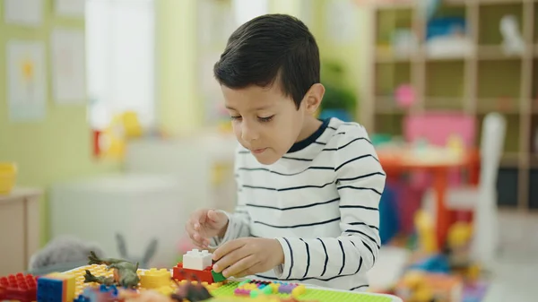 Adorable Hispanic Boy Playing Construction Blocks Sitting Table Kindergarten — Zdjęcie stockowe
