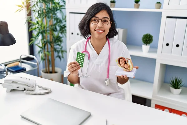 Young Hispanic Doctor Woman Holding Anatomical Model Uterus Fetus Birth — Zdjęcie stockowe