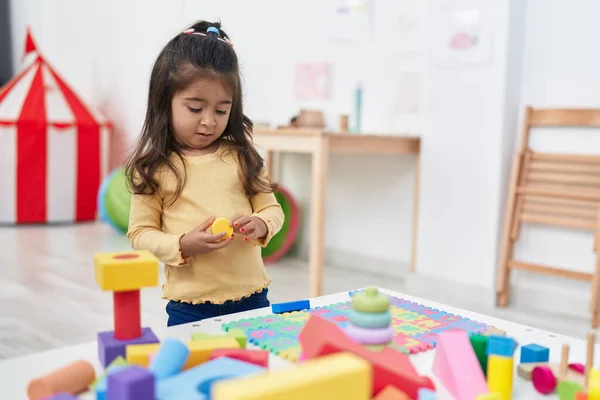 Adorable Hispanic Girl Playing Construction Blocks Standing Kindergarten — Foto de Stock