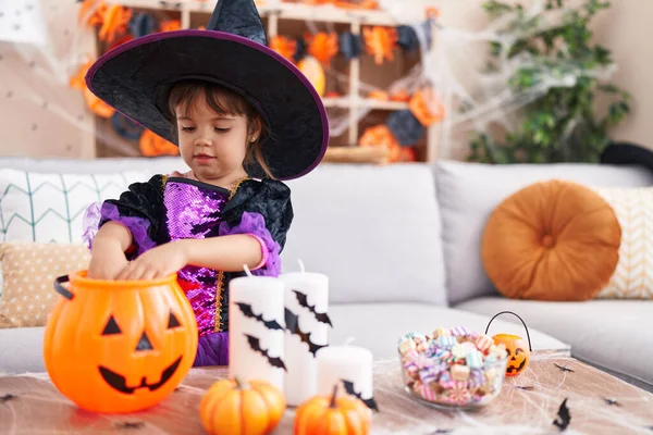 Adorable Hispanic Girl Having Halloween Party Putting Sweets Pumpkin Basket — Stok fotoğraf