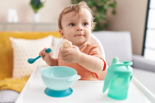 Adorable Blond Toddler Sitting Highchair Eating Snack Home — Stock Photo, Image