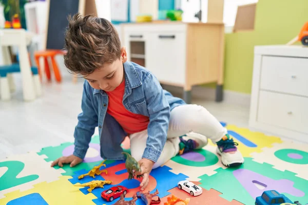 Adorable Hispanic Toddler Sitting Floor Playing Dino Toy Kindergarten — Stock Photo, Image