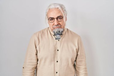 Middle age man with grey hair standing over isolated background depressed and worry for distress, crying angry and afraid. sad expression. 