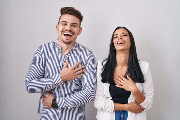 Young Hispanic Couple Standing White Background Smiling Laughing Hard Out — Stockfoto