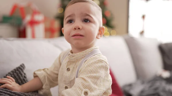 Adorable Toddler Sitting Sofa Christmas Tree Sad Expression Home — Stock Photo, Image
