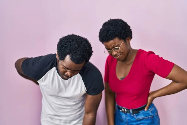 Young African American Couple Standing Pink Background Suffering Backache Touching — Stock Photo, Image