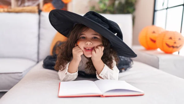 Adorable Hispanic Girl Wearing Halloween Costume Reading Book Home — Stok fotoğraf