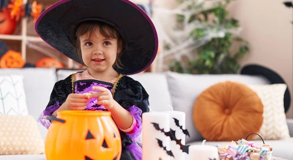 Adorable Hispanic Girl Having Halloween Party Putting Sweets Pumpkin Basket — Foto de Stock
