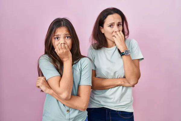Young Mother Daughter Standing Pink Background Looking Stressed Nervous Hands — Stockfoto