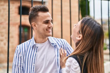 Man and woman couple smiling confident standing together at street