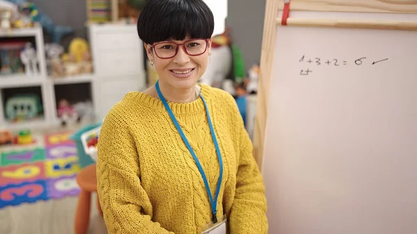Young Chinese Woman Preschool Teacher Smiling Confident Sitting Chair Kindergarten — ストック写真