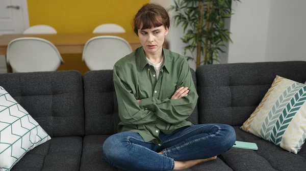 Young Caucasian Woman Sitting Sofa Disgusting Expression Home — Foto de Stock