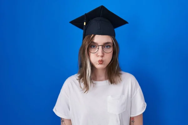Blonde Caucasian Woman Wearing Graduation Cap Puffing Cheeks Funny Face — Stockfoto