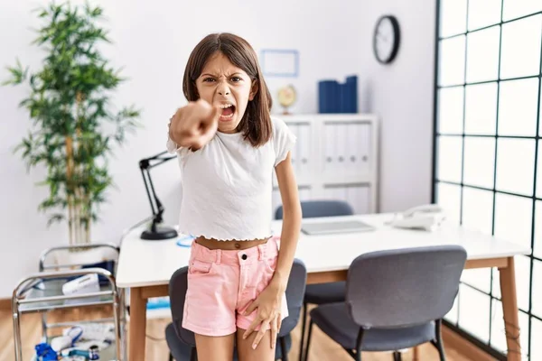 Young Hispanic Girl Standing Pediatrician Clinic Pointing Displeased Frustrated Camera — Stock Photo, Image