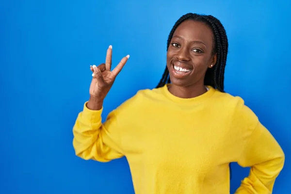Beautiful Black Woman Standing Blue Background Smiling Looking Camera Showing — Stok fotoğraf