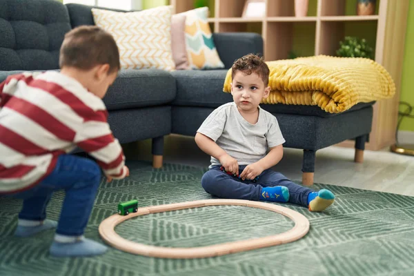 Two Kids Playing Train Toy Sitting Floor Home — Stok fotoğraf